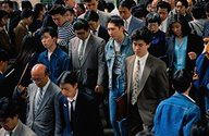 photo of a busy Japanese sidewalk at rush hour