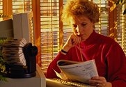 photo of a woman working at a computer work station