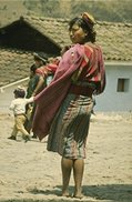 photo of a traditionally dressed Maya woman in her village