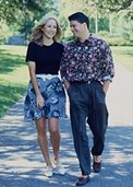 photo of a man and a woman walking together illustrating several polygenic trait differences: stature, hair color, and body shape