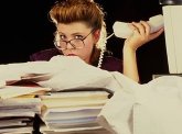 photo of a very over-worked woman in a business office